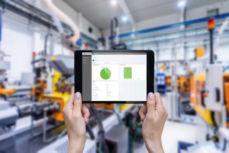 two hands clutching tablet showing production line analytics