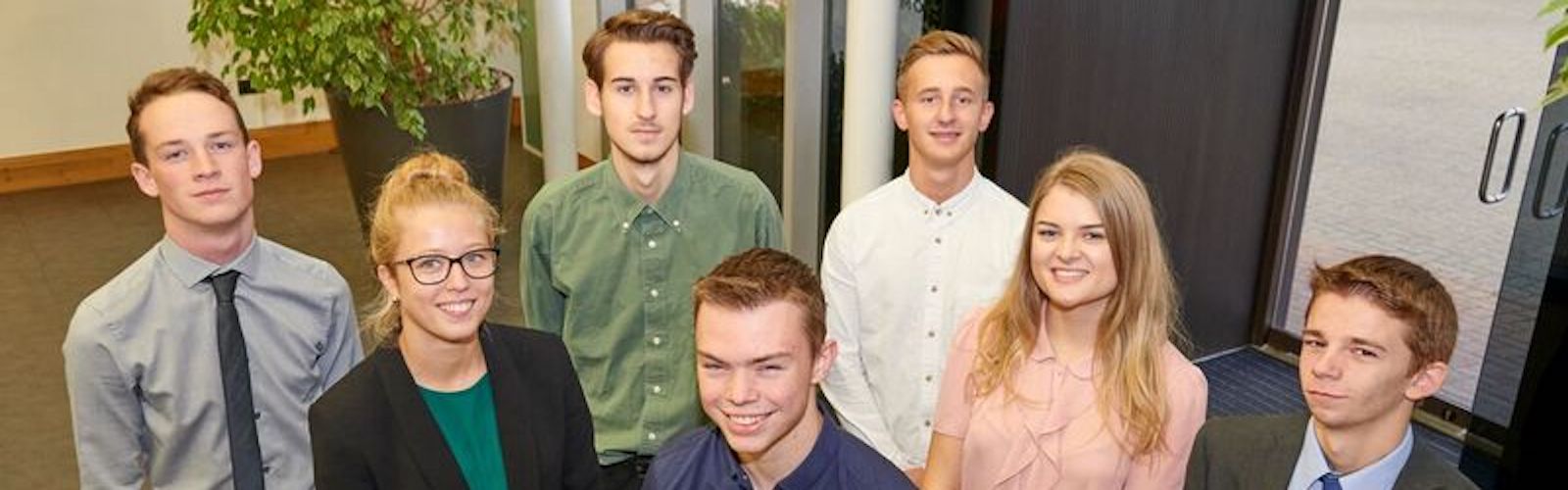 A group of young people gathered at Domino Printing reception ready to start their apprenticeships 