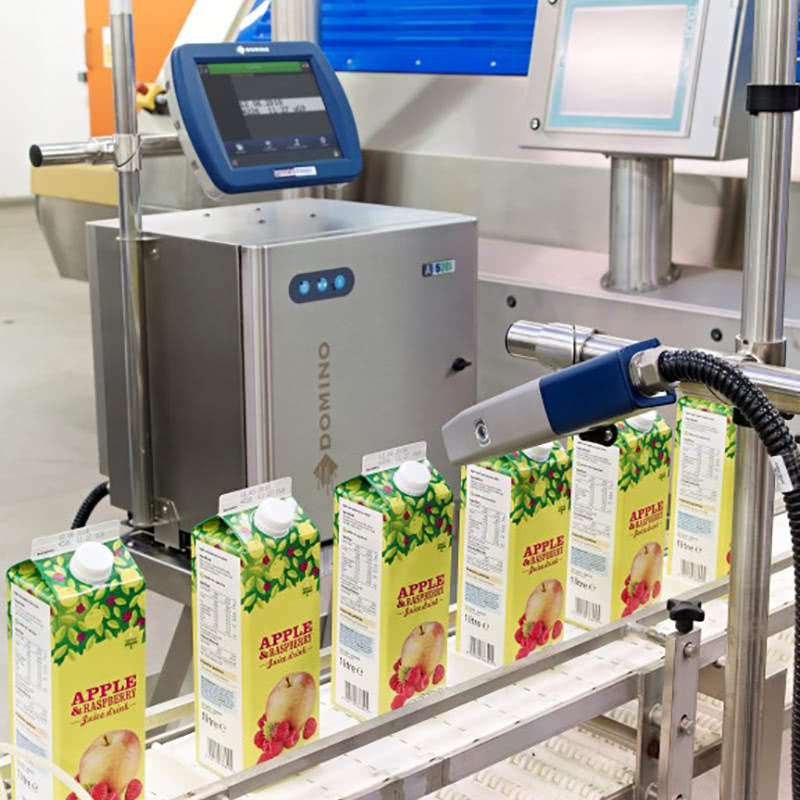 Apple and raspberry juice packaging in production for printing 2D codes using laser printers