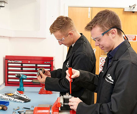 Domino apprentices working in factory