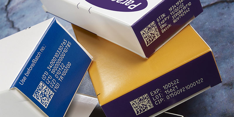 Sample of codes, including data matrix and batch codes, on cardboard pharmaceutical packaging