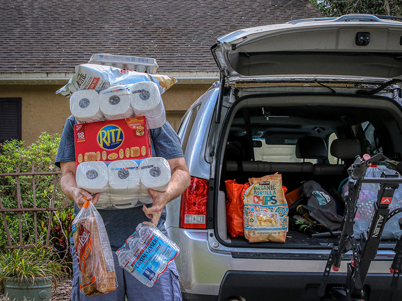 Person carrying shopping items to car