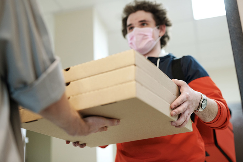 Person carrying cardboard boxes