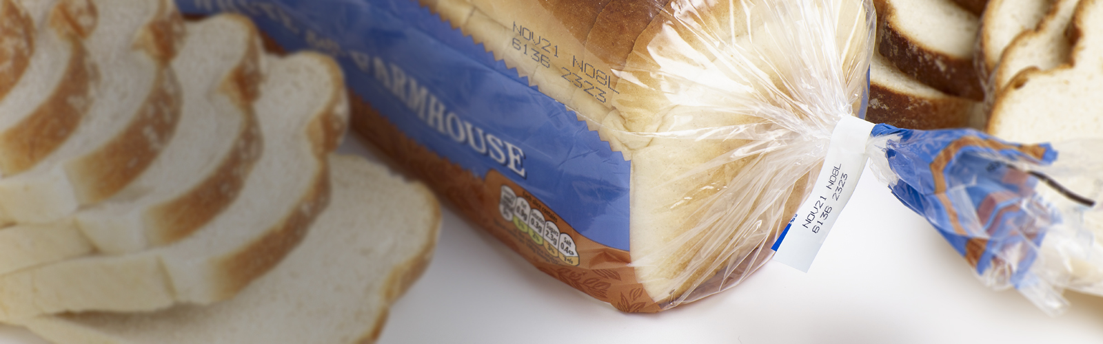 Blue cij printer code on clear bread packaging, including best before date