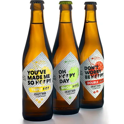 Domino label printed and applied onto a brown glass bottle