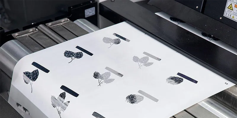 Digital foil print onto white substrate by Domino's K600i